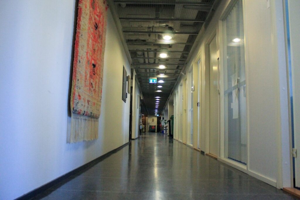 Pitkä käytävä. Katossa valaisimet.